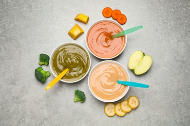 Photo of Healthy baby food and ingredients on grey table, flat lay