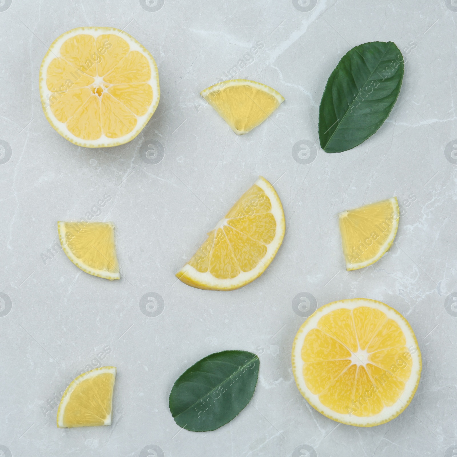 Photo of Flat lay composition with lemon slices on grey marble table