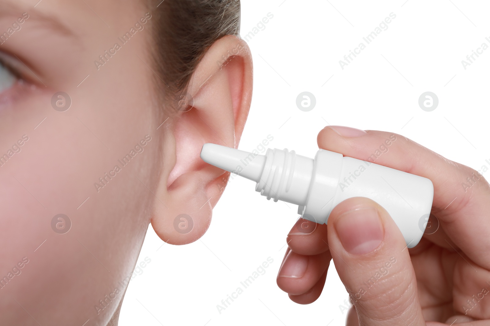 Photo of Mother dripping medication into daughter's ear on white background, closeup