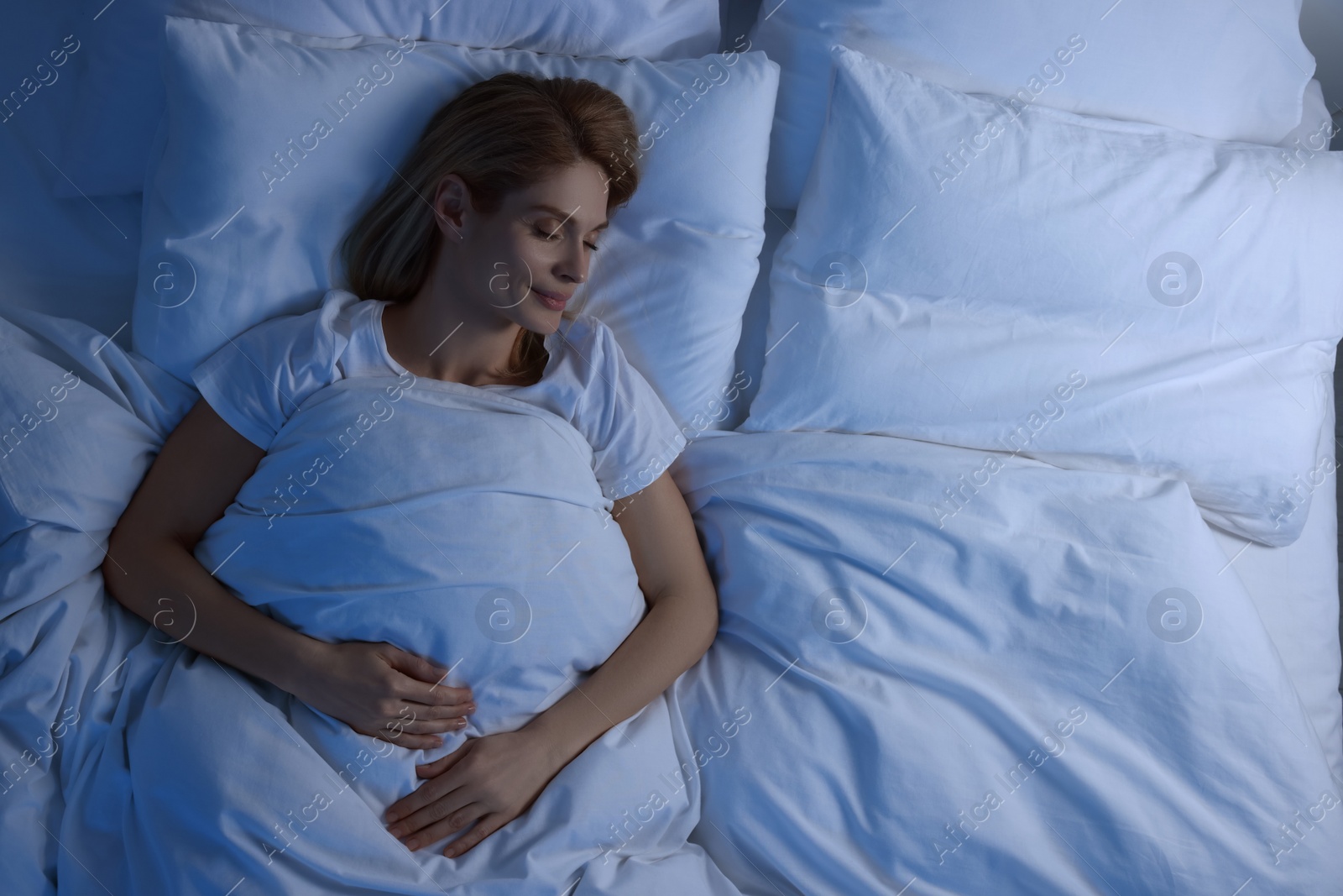 Photo of Woman sleeping in bed at night, above view. Space for text