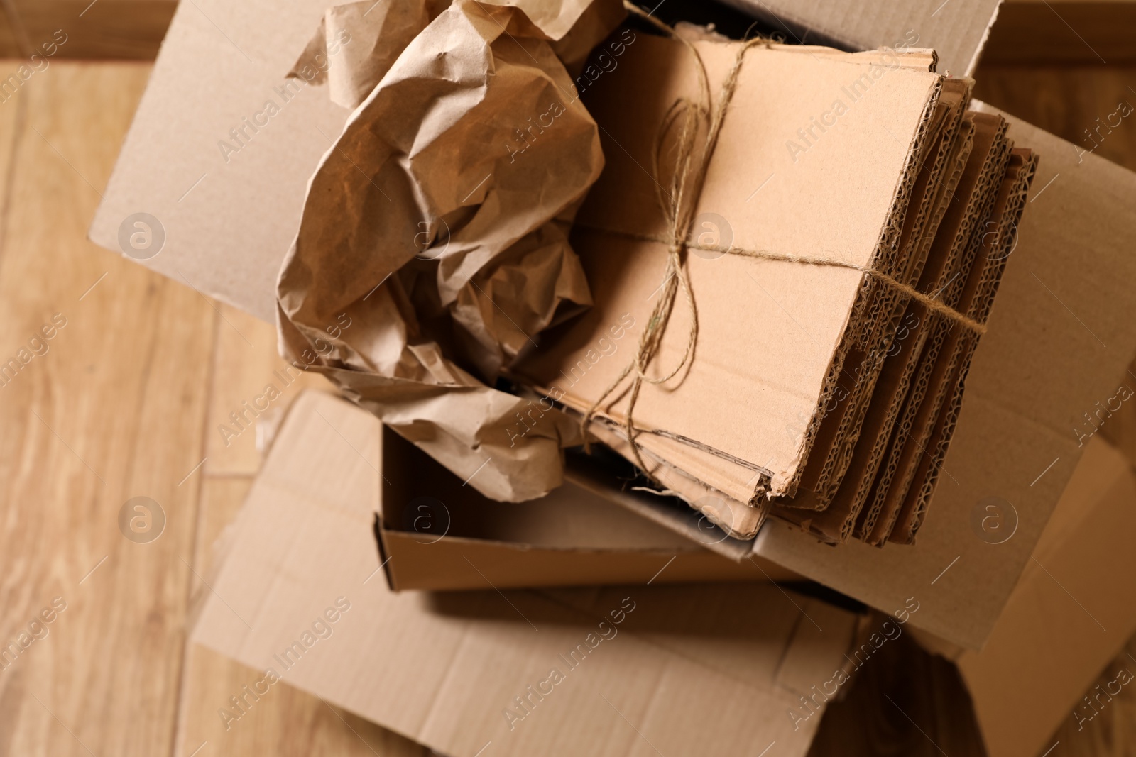 Photo of Heap of waste paper on wooden floor, above view