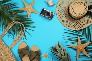 Photo of Frame of beach objects on light blue background, flat lay. Space for text
