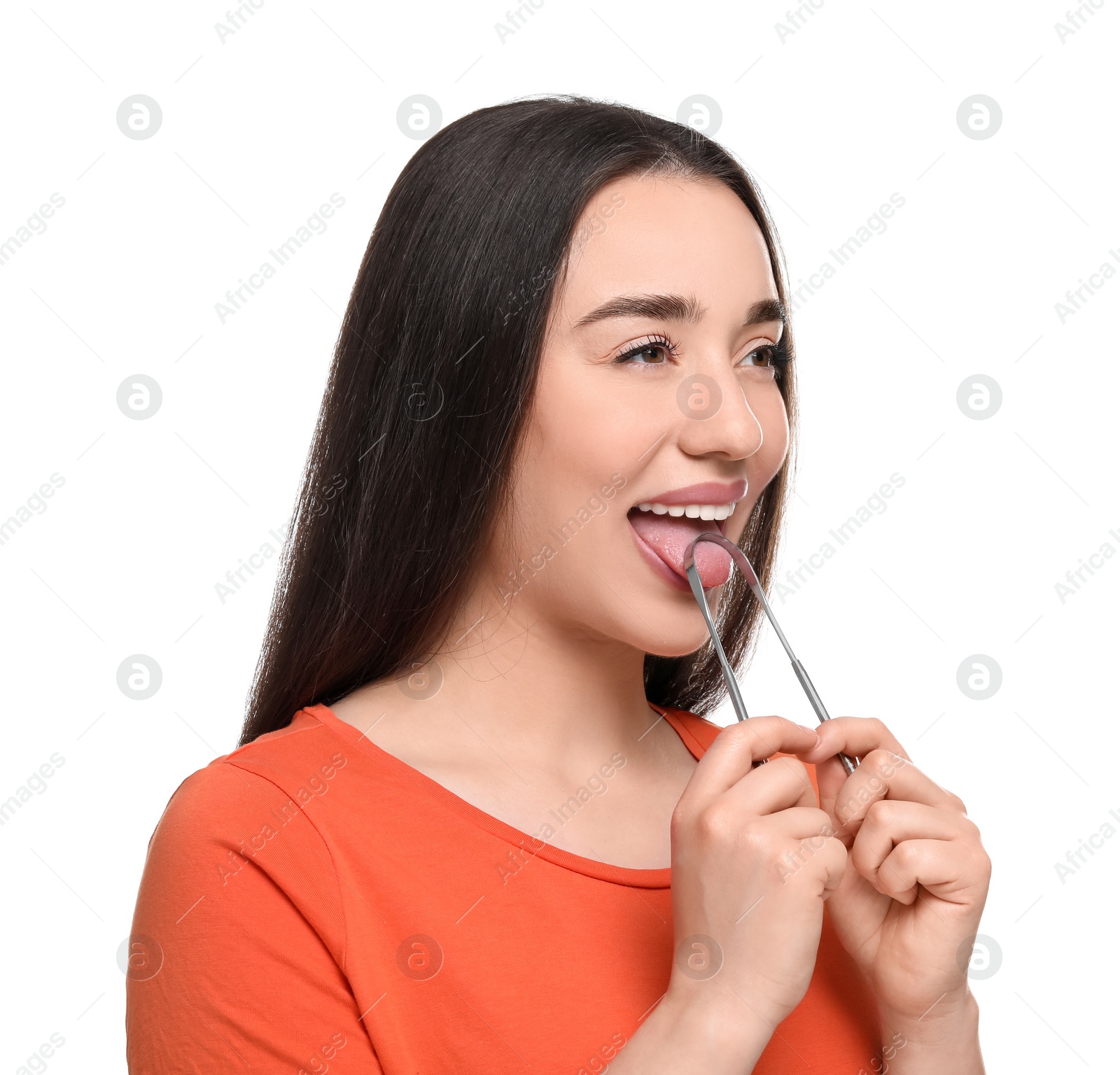 Photo of Happy woman brushing her tongue with cleaner on white background