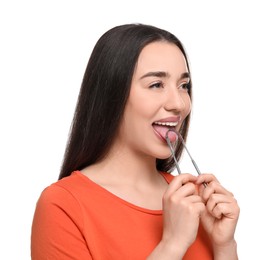 Photo of Happy woman brushing her tongue with cleaner on white background