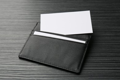 Photo of Leather business card holder with blank cards on grey table