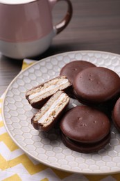 Tasty choco pies on wooden table. Snack cakes