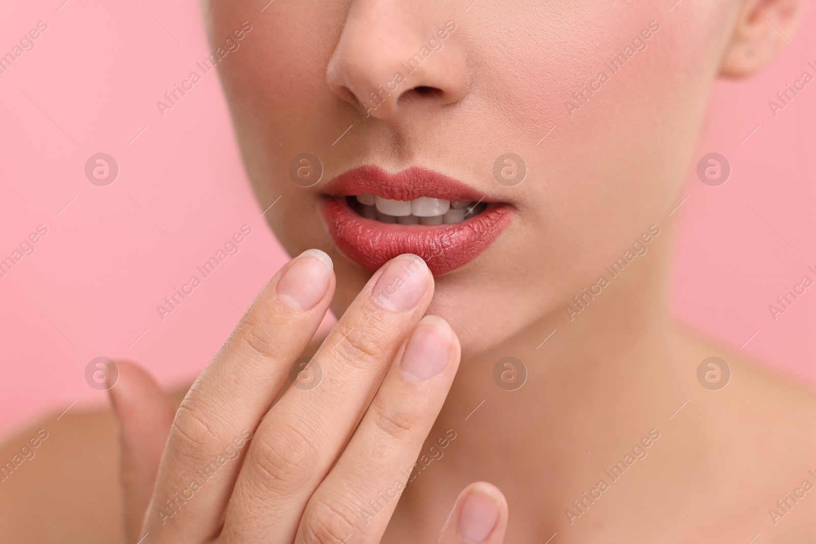 Photo of Woman with beautiful lips on pink background, closeup