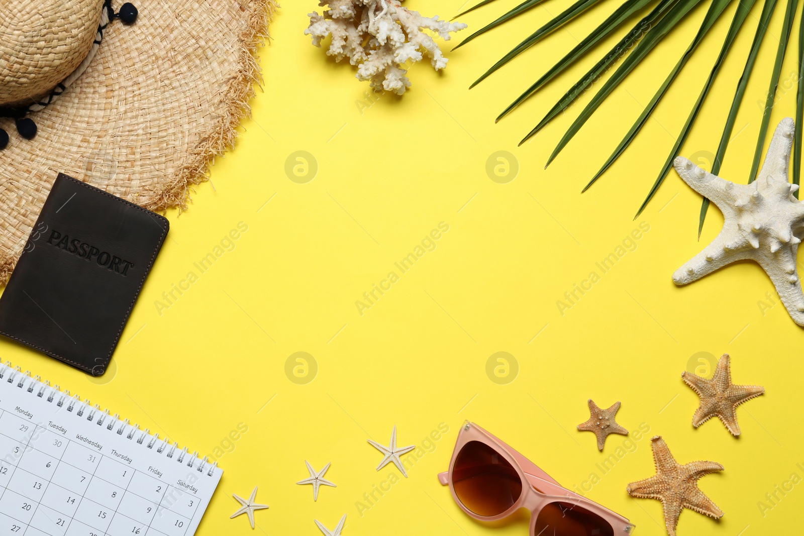 Photo of Frame made with beach accessories on yellow background, flat lay. Space for text