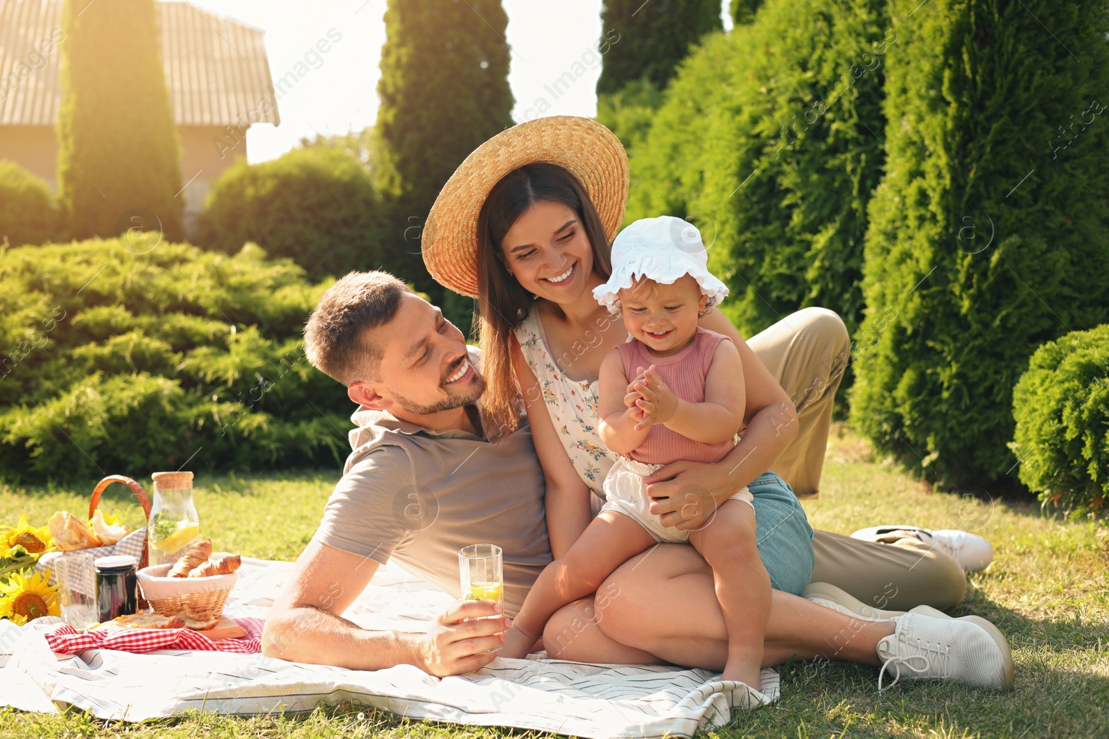 Photo of Happy family having picnic in garden on sunny day