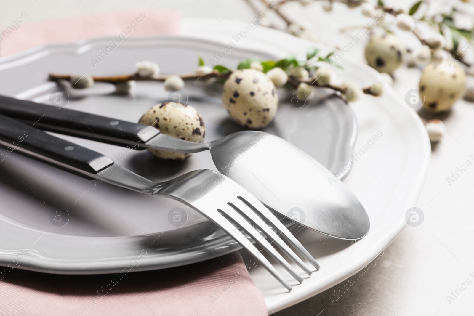 Photo of Festive Easter table setting with quail eggs on color background, closeup