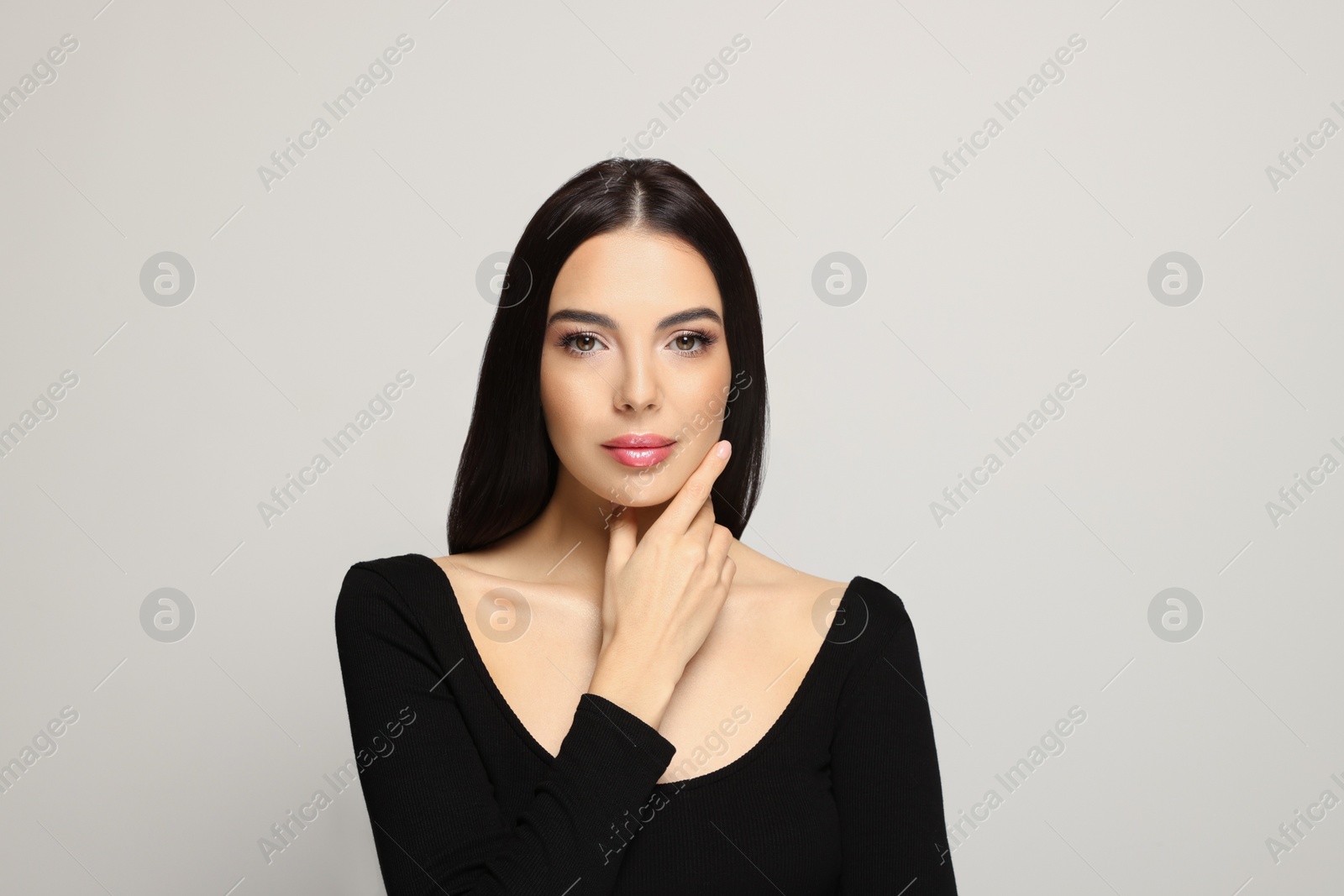 Photo of Portrait of beautiful young woman on light grey background