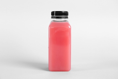 Photo of Bottle with delicious fresh juice on light background