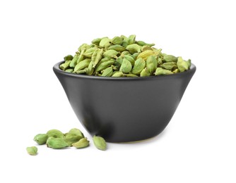 Ceramic bowl and dry cardamom seeds on white background
