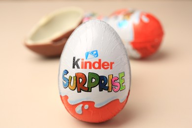 Photo of Slynchev Bryag, Bulgaria - May 25, 2023: Kinder Surprise Eggs on beige background, closeup