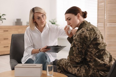 Photo of Psychotherapist working with military woman in office