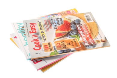 Photo of Stack of different magazines on white background