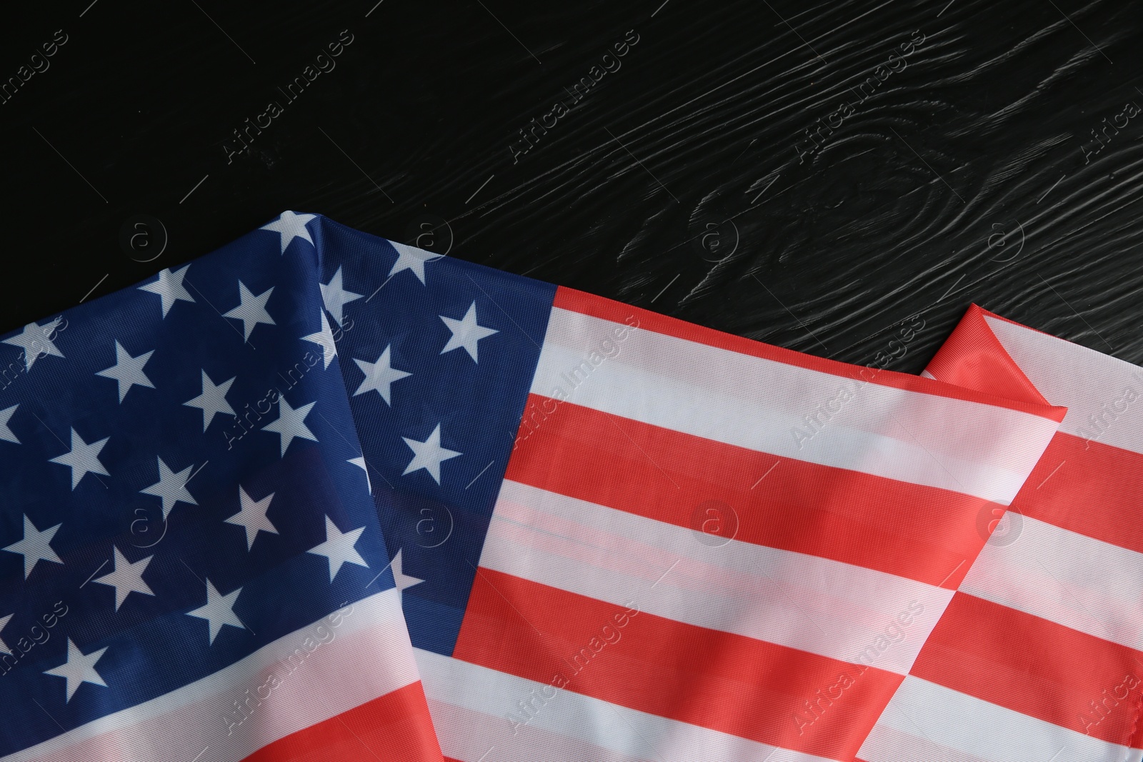 Photo of Flag of USA on black wooden table, top view