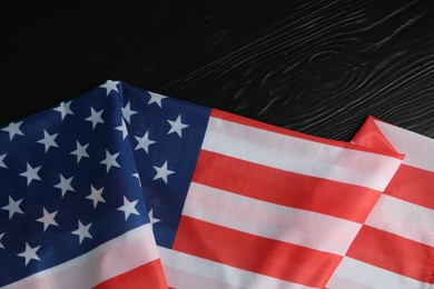 Photo of Flag of USA on black wooden table, top view