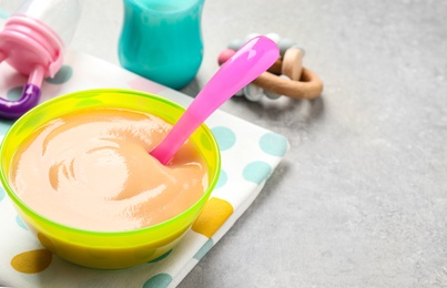 Photo of Healthy baby food on grey table. Space for text