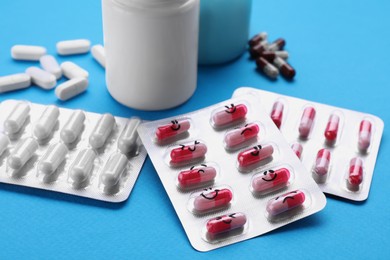 Photo of Different antidepressants with emoticons on light blue background