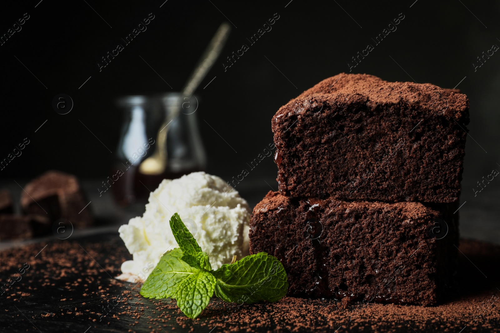 Photo of Fresh brownies served with ice-cream on slate plate, space for text. Delicious chocolate pie