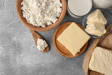 Photo of Tasty homemade butter and dairy products on grey table, flat lay. Space for text