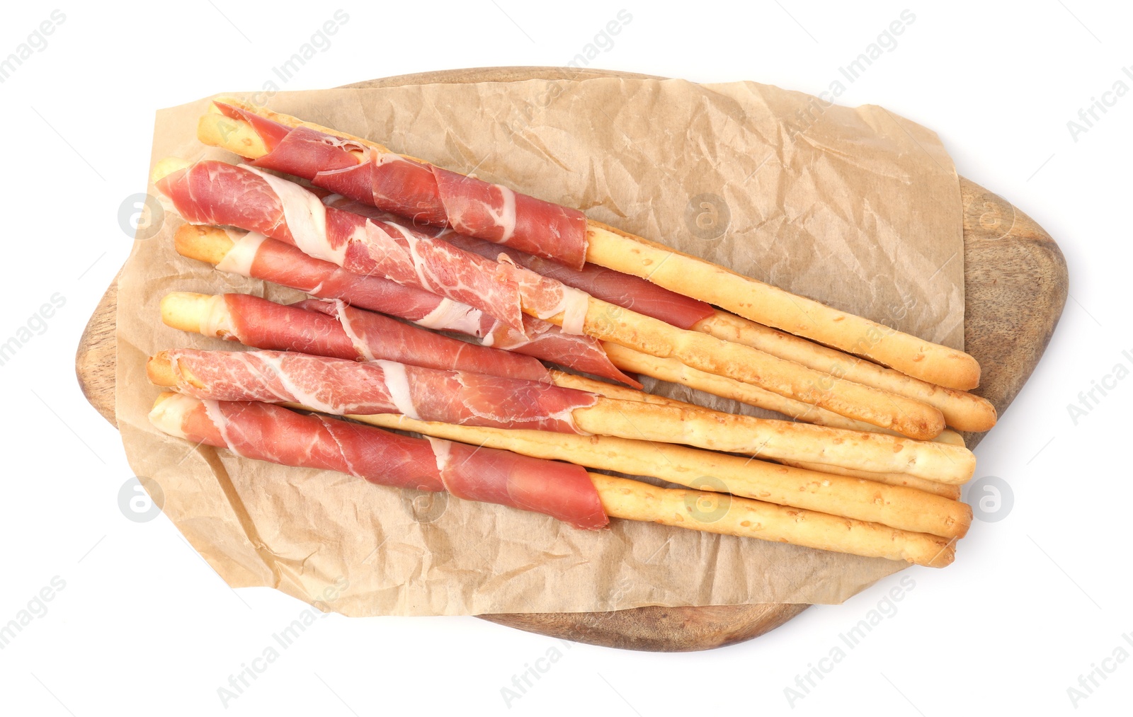 Photo of Delicious grissini sticks with prosciutto on white background, top view