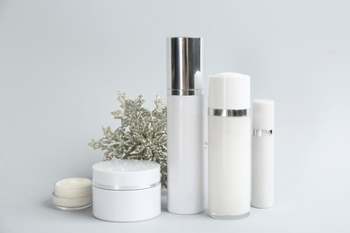 Photo of Beautiful composition with cosmetic products on light grey background. Winter care