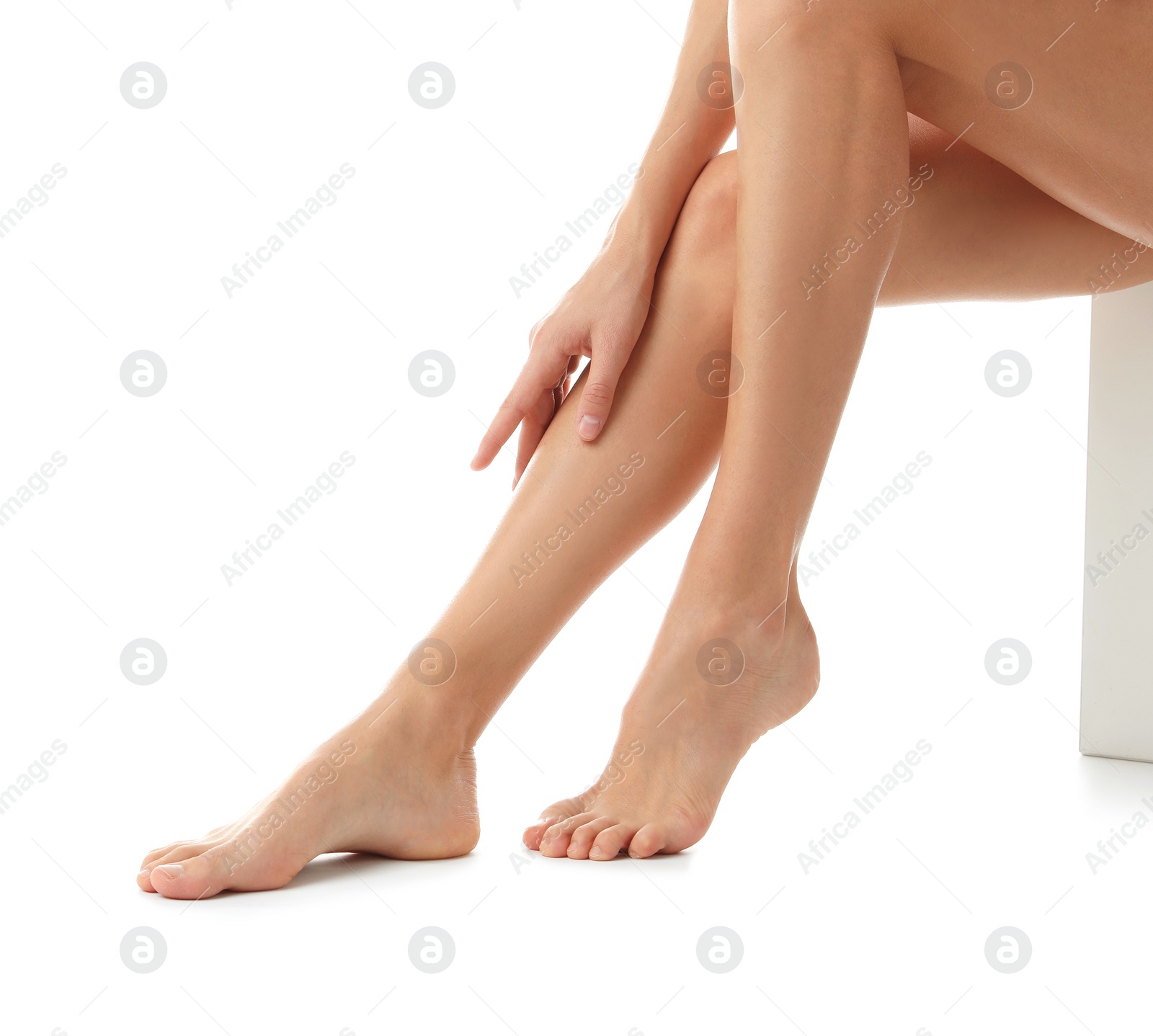 Photo of Young woman with beautiful long legs on white background, closeup