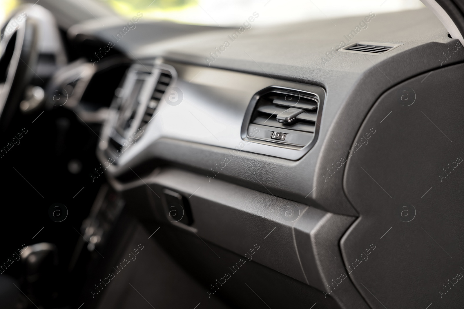 Photo of Air vent and airbag module in car, closeup