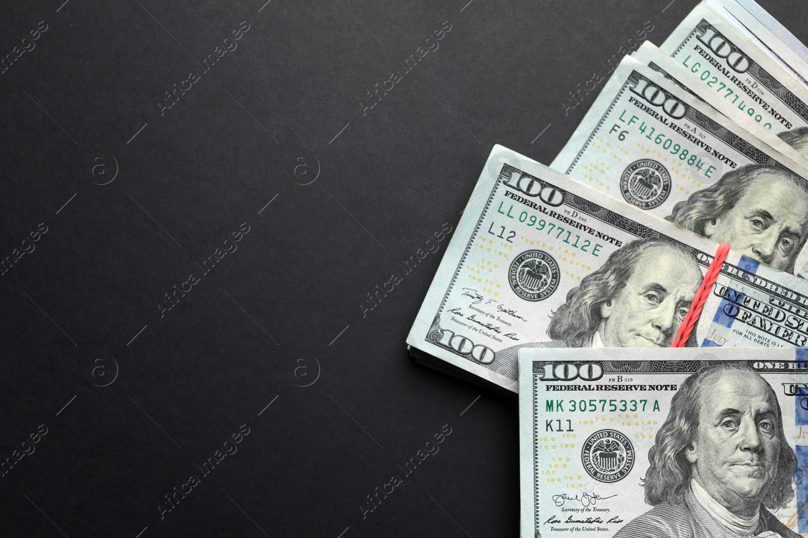 Photo of Many dollar banknotes on black background, flat lay. Space for text