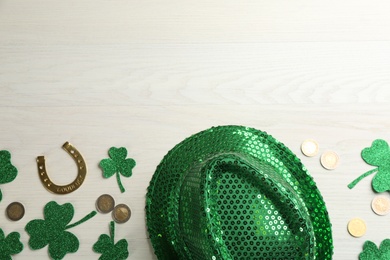 Flat lay composition with leprechaun hat on white wooden table, space for text. St Patrick's Day celebration