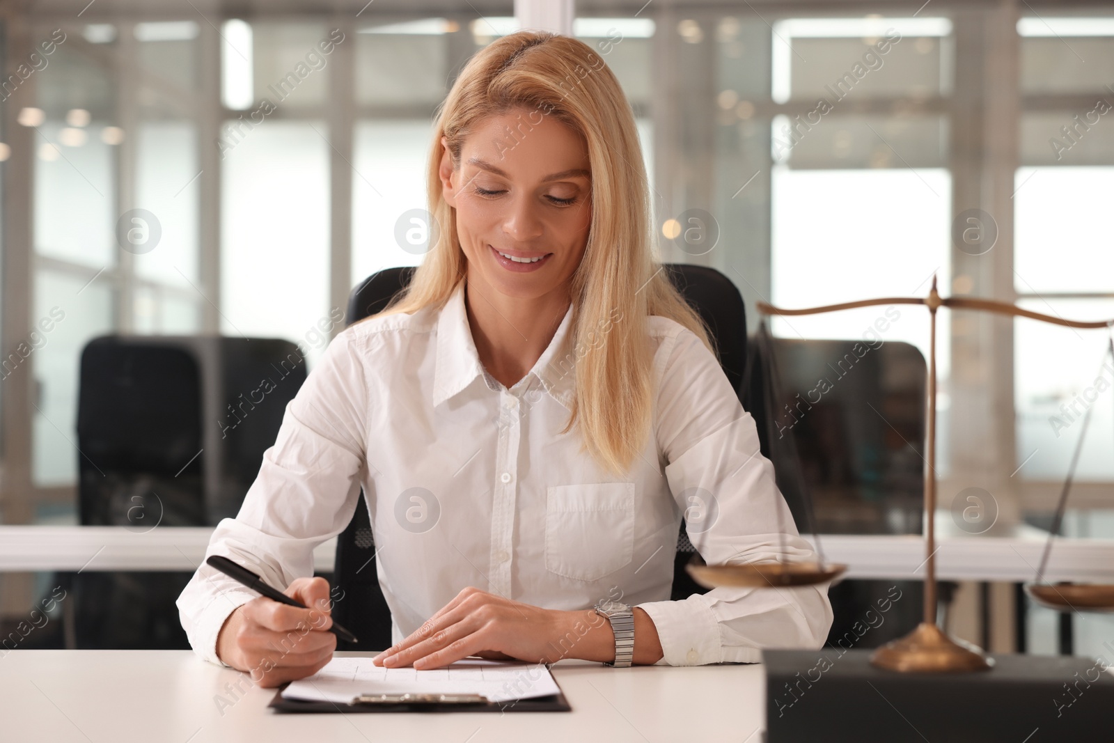 Photo of Portrait of smiling lawyer working at table in office