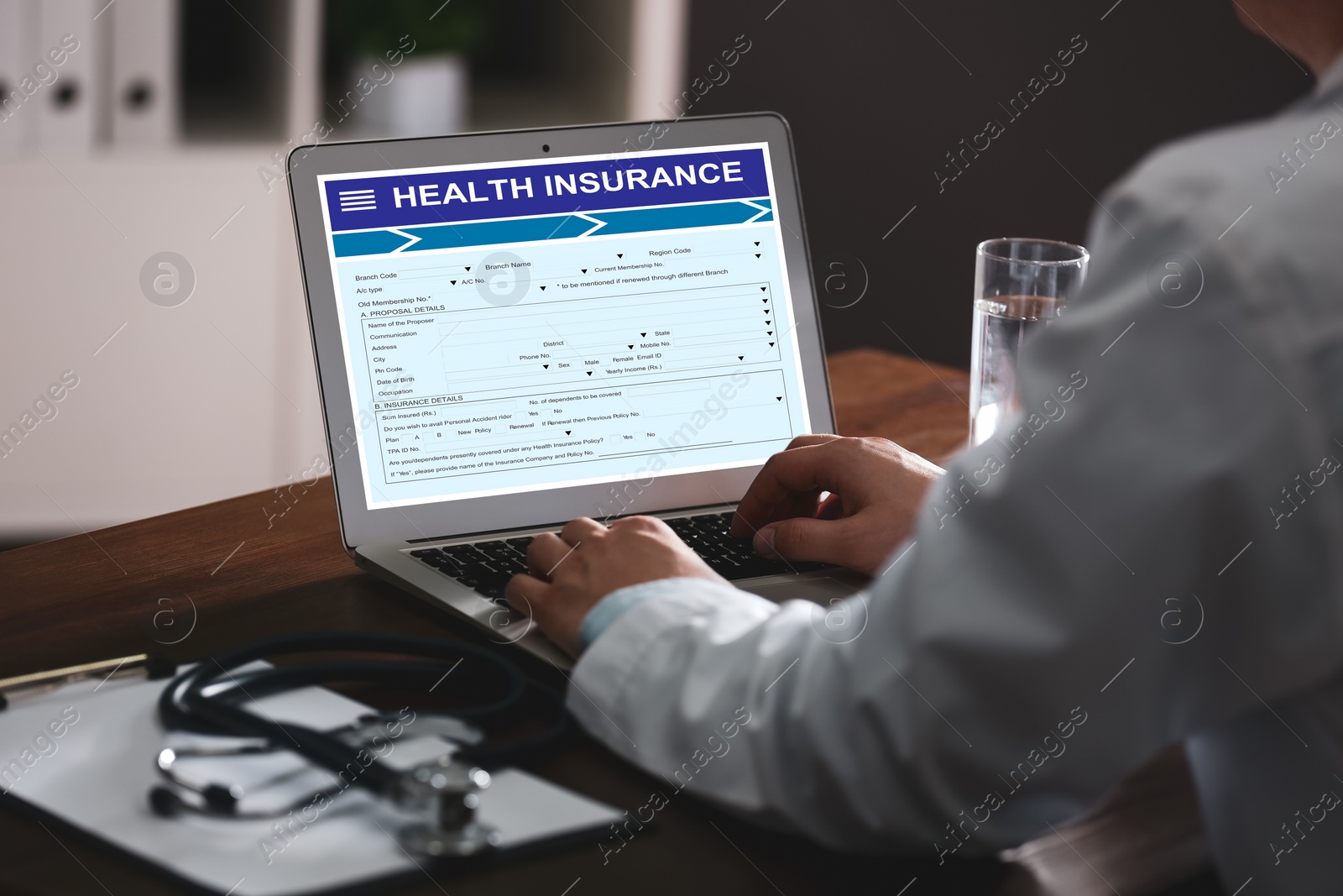 Image of Doctor with modern laptop indoors, closeup. Health insurance