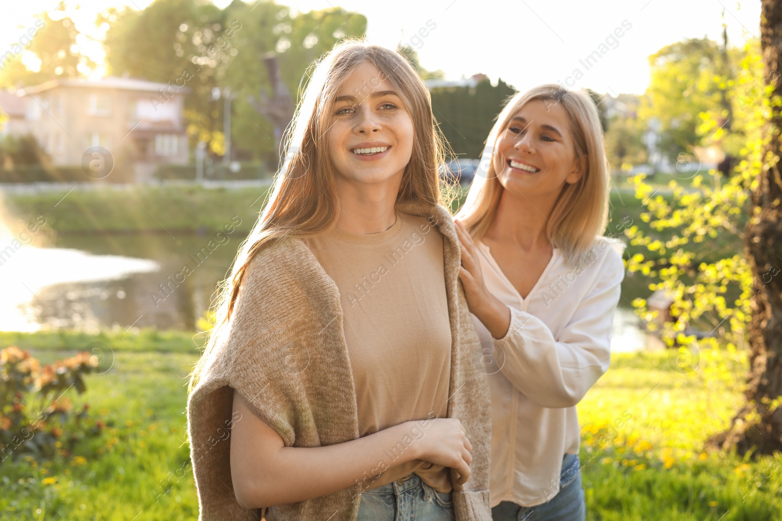 Photo of Happy mother with her daughter spending time together in park on sunny day