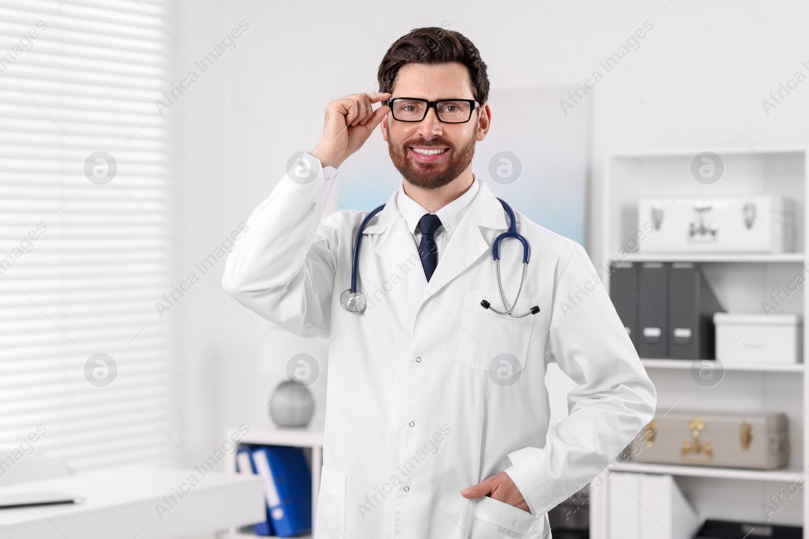 Photo of Medical consultant with glasses and stethoscope in clinic