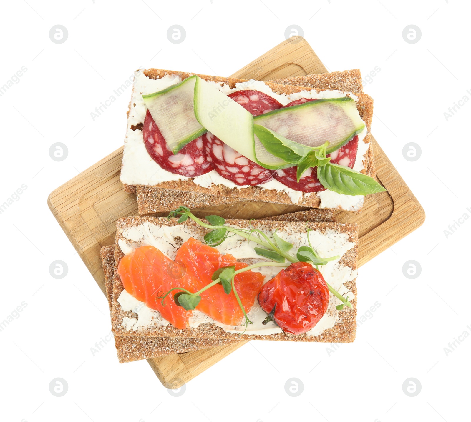 Photo of Fresh rye crispbreads with different toppings on white background, top view