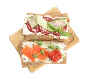 Photo of Fresh rye crispbreads with different toppings on white background, top view