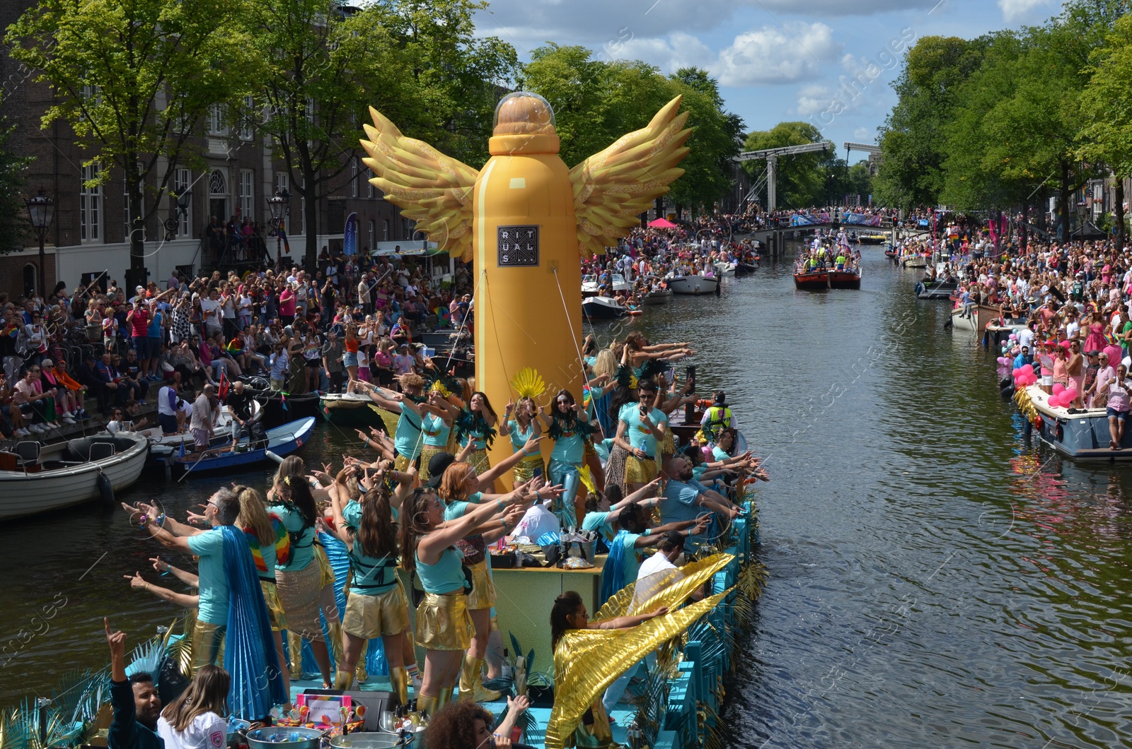 Photo of AMSTERDAM, NETHERLANDS - AUGUST 06, 2022: Many people in boats at LGBT pride parade on river