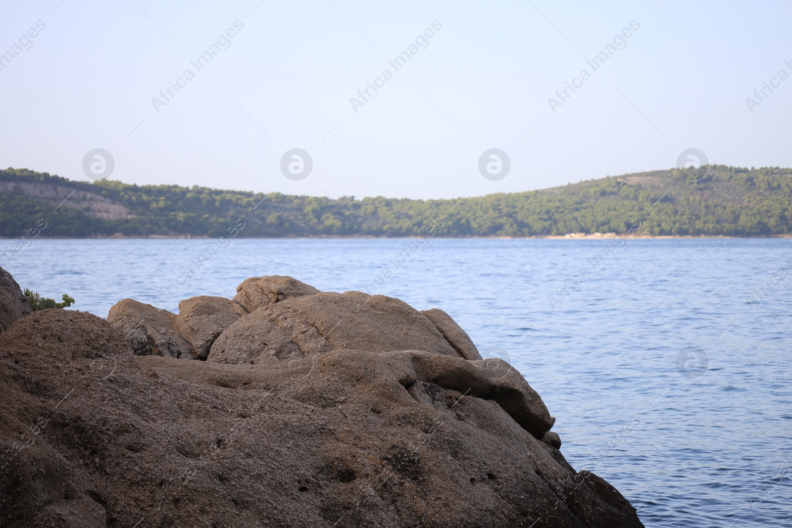 Photo of Beautiful view of sea coast with stones on summer day