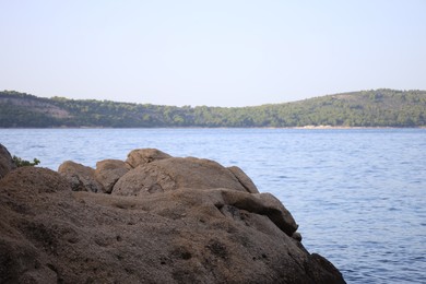 Beautiful view of sea coast with stones on summer day