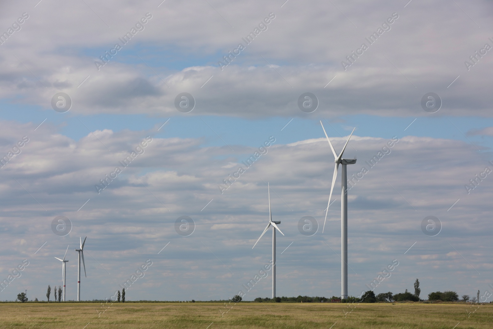 Photo of Beautiful view of field with wind turbines. Alternative energy source