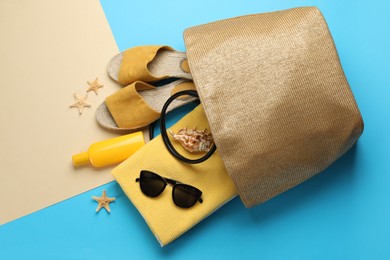 Stylish bag and beach accessories on color background, flat lay