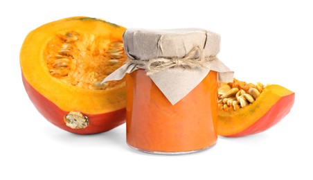 Jar of pumpkin jam and fresh pumpkin on white background