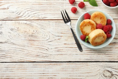 Photo of Delicious cottage cheese pancakes with raspberries and mint on white wooden table, flat lay. Space for text