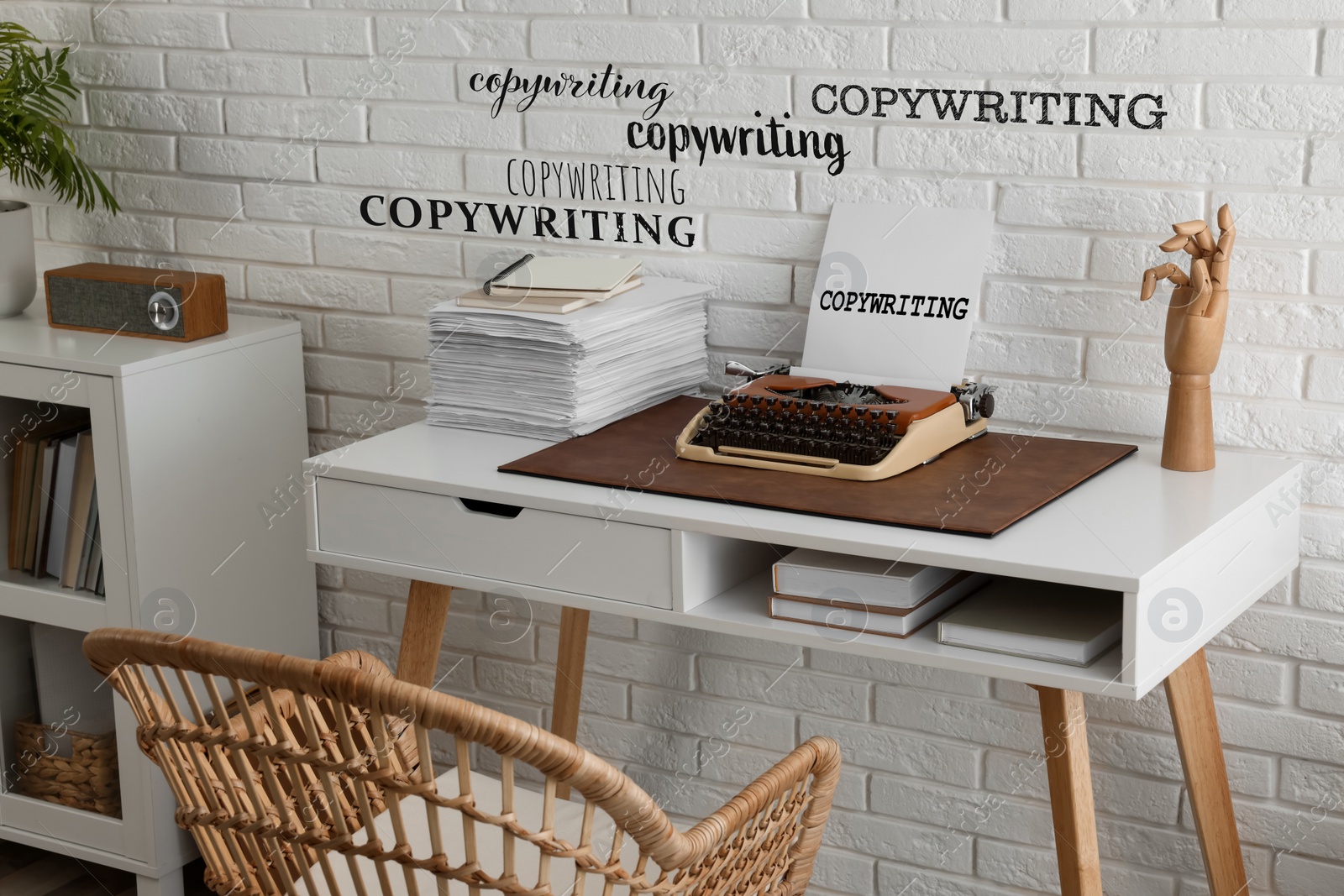 Image of Word Copywriting in different fonts on paper and wall. Workplace with typewriter