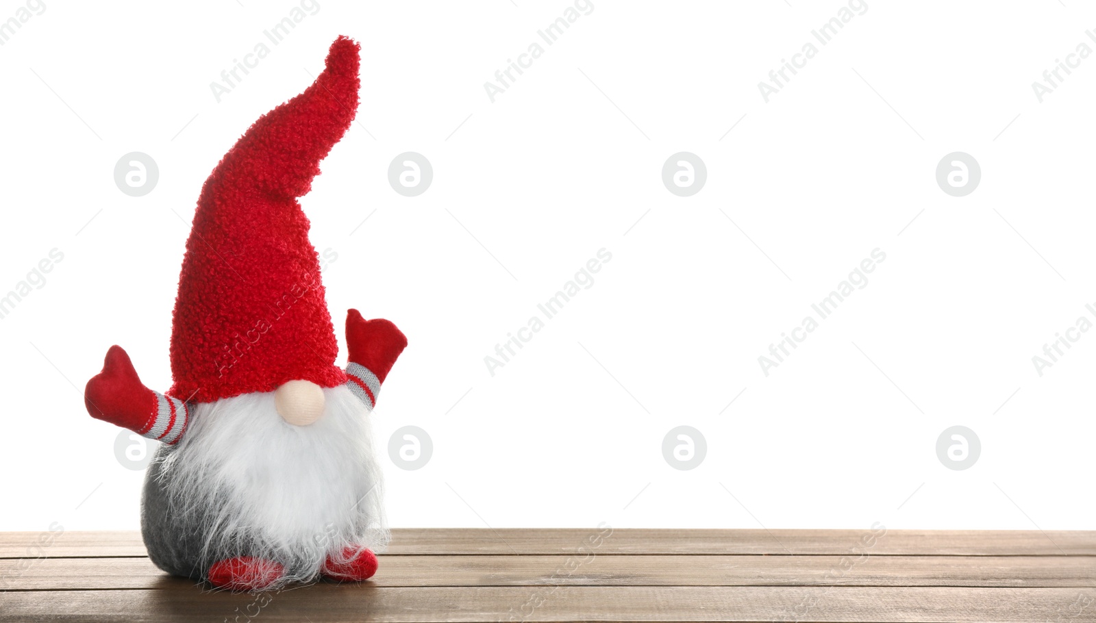 Photo of Funny Christmas gnome on wooden table against white background. Space for text