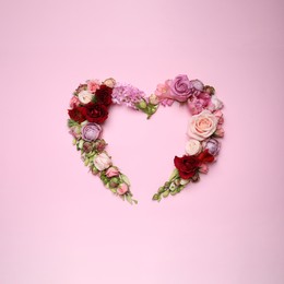 Photo of Beautiful heart shaped floral composition on pink background, flat lay