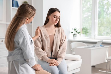 Photo of Professional doctor working with patient in hospital, space for text