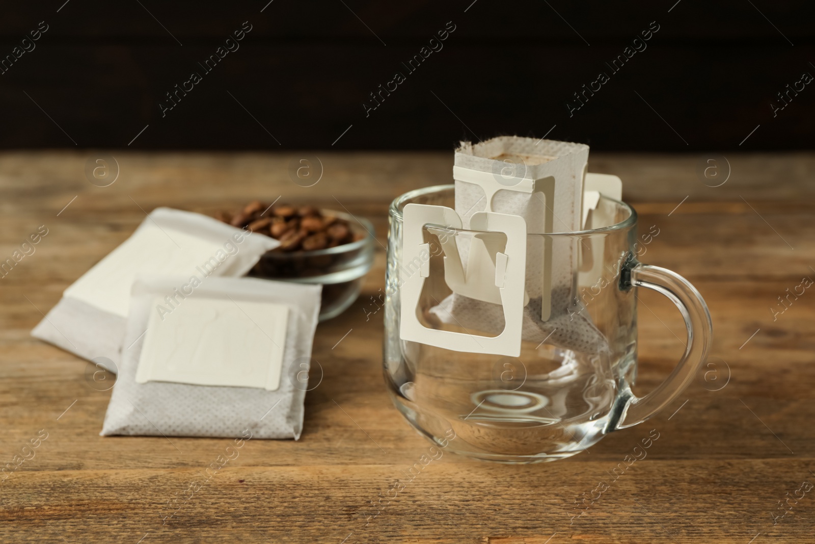 Photo of Drip coffee in glass cup on wooden table